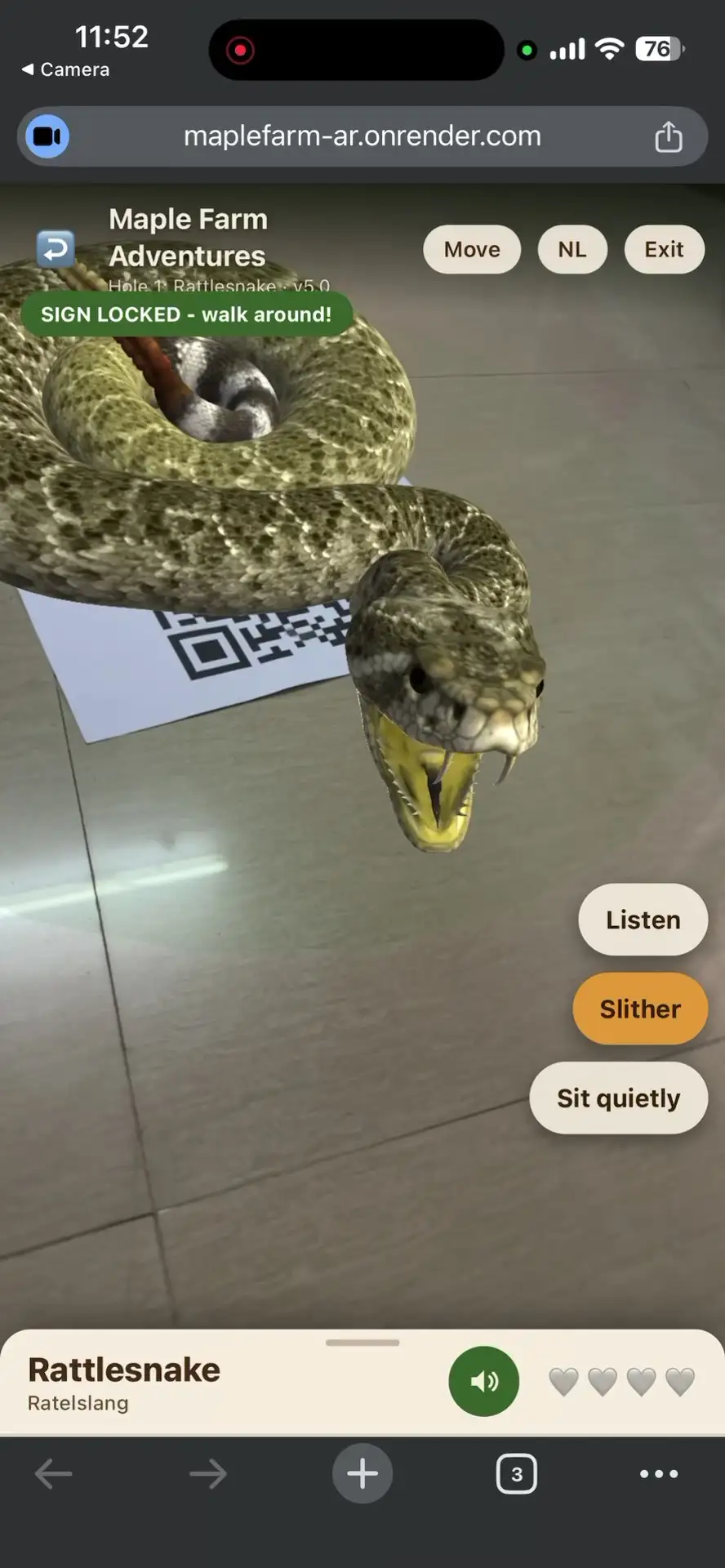 Close up of the rattlesnake in augmented reality with its mouth open and fangs showing, its body coiled over the printed sign