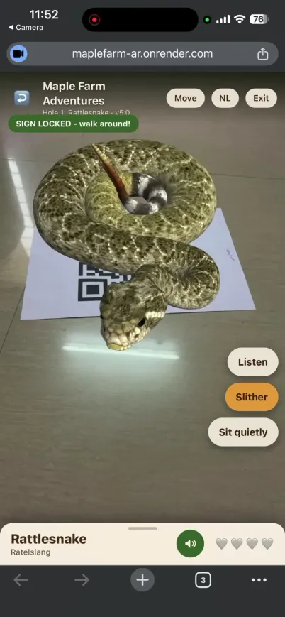 Rattlesnake coiled on a printed QR sign in augmented reality, with a green Sign Locked badge showing the anchor is holding